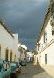 Narrow street, black clouds looming